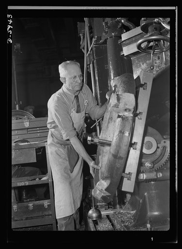 Manpower. Americans all. Born in Rumania, George Sackwar is doing what he can to shoot up the Axis - not with a gun but with the radial drill on which he makes parts for medium tanks. One of many hundreds of loyal, foreign-born Americans who work in this large Midwest tank plant, Sackwar is proud of