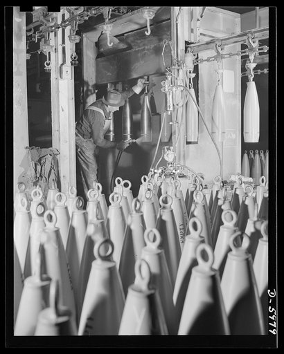 Production. 155mm shells. Spray painting the outsides of 155mm shells in a De Vilbiss spray booth in a converted Midwest auto plant. Willy's, Toledo, Ohio