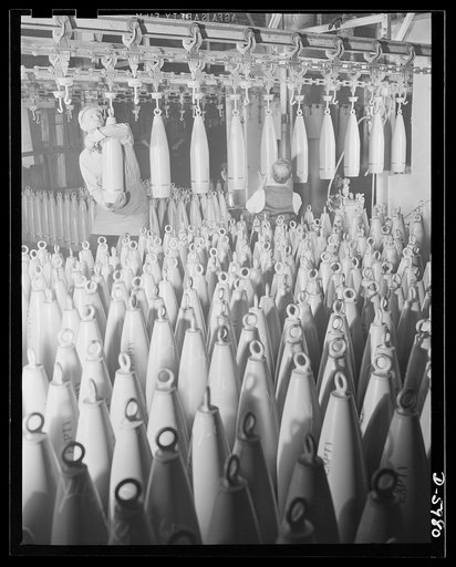 Production. 155mm shells. Government inspectors check the painting of 155mm shells as they pass by on the overhead drying conveyor of a converted auto plant. Willy's, Toledo, Ohio