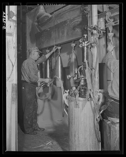 Production. 155mm shells. Spray painting the outsides of 155mm shells in a De Vilbiss spray booth in a converted Midwest auto plant. Willy's, Toledo, Ohio
