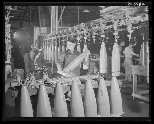 Production. 155mm shells. Unloading completed 155mm shell bodies from an overhead drying conveyor at a converted Midwest auto plant. Willy's, Toledo, Ohio