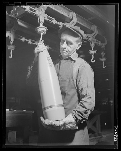 Production. 155mm shells. Unloading completed 155mm shell bodies from an overhead drying conveyor at a converted Midwest auto plant. Willy's, Toledo, Ohio