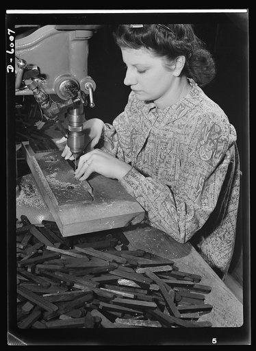 Conversion. Pianos to airplane motors. Prior to the conversion of a Chicago piano factory to the manufacture of parts for trainer planes, Lorraine Avezzano operated this boring machine to prepare piano keyboards for further assembly. Today she uses the same machine to process connecting rods for tra