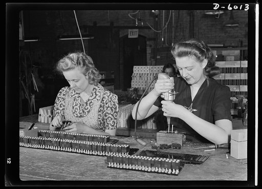 Conversion. Pianos to airplane motors. Erstwhile piano keyboard assemblers, Clara Bernas (left) and Bernice Struts, employees of a Chicago piano factory which has been converted to war production, now assemble crank bearings for pneumatic trainer-plane motors. Bernice operates the electric screwdriv