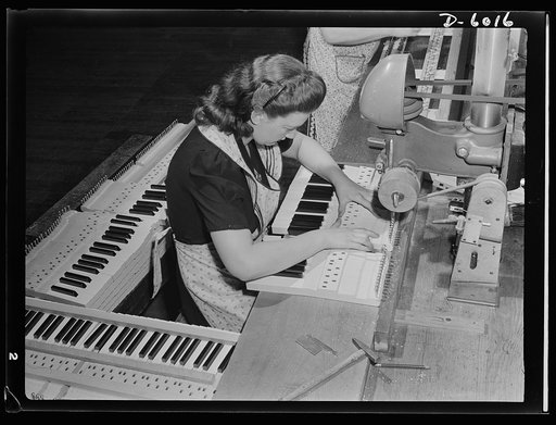 Conversion. Pianos to airplane motors. A pretty girl surrounded by melody! Employed by a Chicago piano factory which has recently been converted to war production, Bernice Strutz uses a drill press to set capstan screws in keyboards. Today, however, she's assembling trainer-plane motors to be used b
