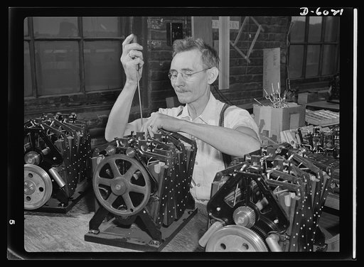 Conversion. Pianos to airplane motors. From musical instruments to instruments of death. Edward Groe, Nowegian-born employee of a Chicago piano factory, has been regulating the pneumatic motors of trainer planes since the firm's conversion to war production. Employed by this same company since 1909,
