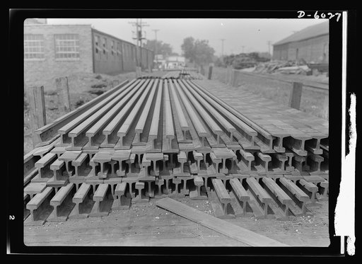 Transportation. Shipping rails east. Flat cars in central Iowa stacked with rails ready to be shipped eastward, where transportation demands are heaviest