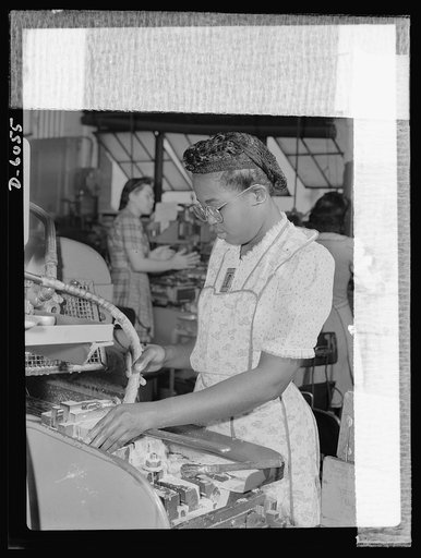 Women in war. Machine gun production operators. One of 2,000 women currently employed in a Midwest war plant, this young Negro worker has proven a competent and earnest machine operator. She processes gun parts in this plant which has been converted from the production of spark plugs to machine guns