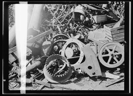 Salvage. Farm scrap. Scrap today, armaments tomorrow. Collected from dozens of Michigan farms, this pile of valuable scrap metal awaits transport to a steel mill where it will be melted down into weapons for America's fighting men