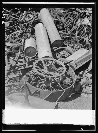 Salvage. Farm scrap. Hay rakes, farm wheels, hot-water tanks and auto springs long past their prime are contributed by Michigan farmers to the scrap-collection drive. All the scrap metal which America's farmers can no longer use, will be put to immediate and vital use in the war effort