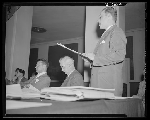 War Labor Board: "Little Steel" hearing. Lee Pressman, Congress of Industrial Organizations (CIO) counselor; Philip Murray, CIO president; and Harold Ruttenberg (speaking), research director, United Steel Workers (USW), at the "Little Steel" hearing held by the War Labor Board at the Hotel Washingto