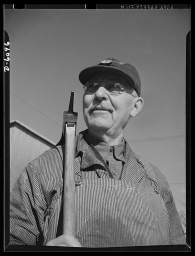 Production. Submarine chasers. An adzeman, master of an ancient craft. Christopher Christophersen, sixty-five, still puts in a full day at an Eastern boatyard shaping oak keels for subchasers. Marine Construction Company, Stamford, Connecticut