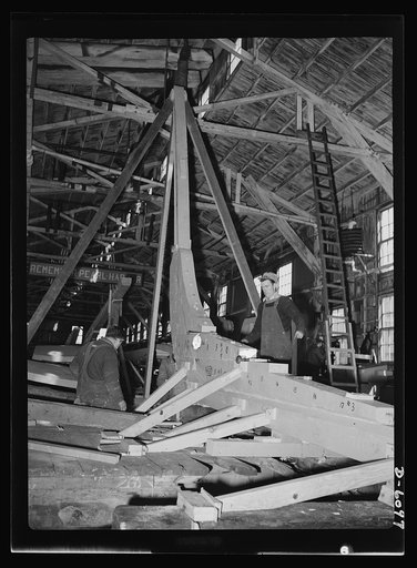 Production. Submarine chasers. The sturdy oak keel of a wooden subchaser is laid at an Eastern boatyard. The stern of the vessel is scarfed to it. The numbers showing along the keel indicate the "stations" or hull sections into which every boat plan is divided. Marine Construction Company, Stamford,
