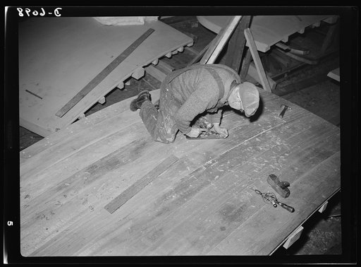 Production. Submarine chasers. The transom, or stern piece, of a wooden subchaser for the Navy is planed smooth before it is attached to the keel at an Eastern boatyard. Marine Construction Company, Stamford, Connecticut