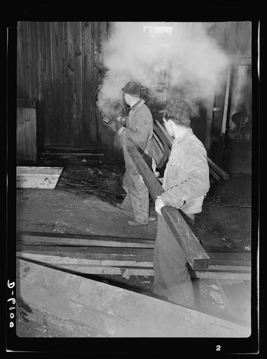 Production. Submarine chasers. Steaming a wooden section for a subchaser under construction at an Eastern boatyard. The wood, blackened by the steam, can now be bent to the required shape. Marine Construction Company, Stamford, Connecticut
