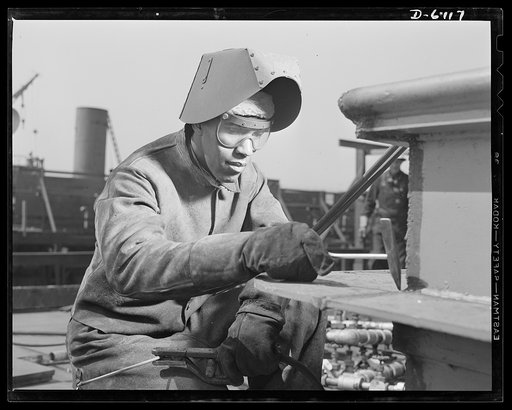 Construction of the liberty ship "Booker T. Washington." Negro skilled workers in many crafts participated in the construction of the "Booker T. Washington," first liberty ship named for a Negro. James Kermit Lucas, welder, is shown working on the top deck of the vessel which bears the name of the n