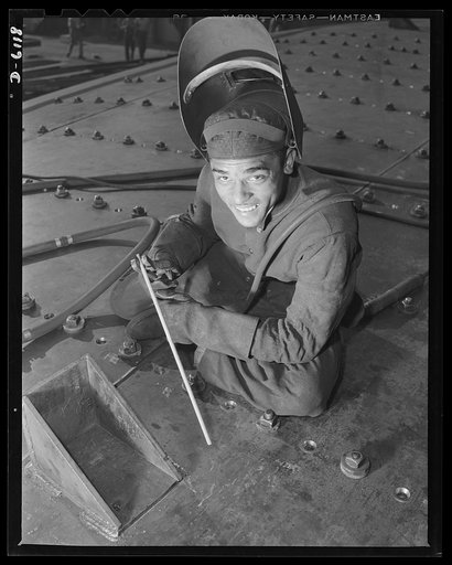Construction of the liberty ship "Booker T. Washington." Booker T. Washington believed in industrial education for Negroes. One Negro youth who heeded his advice and attended Tuskegee Institute in Alabama is now a skilled worker in the shipyard, which has named a liberty ship for the noted Negro edu