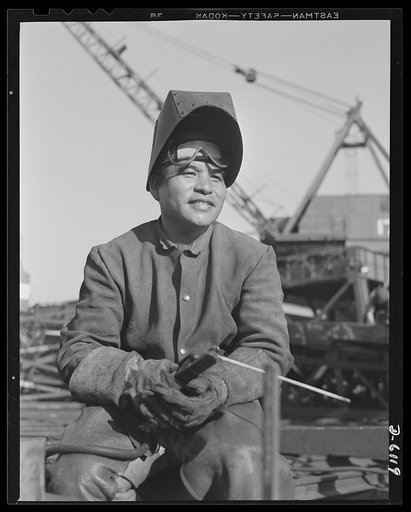 Construction of the liberty ship "Booker T. Washington." Workers of many racial groups participated in the construction of the liberty ship "Booker T. Washington," named for the great Negro educator. Edward Char, Chinese welder, is shown fabricating the double bottom for the ship at the California S