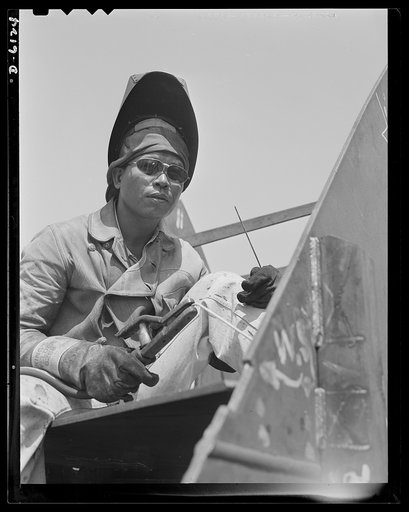 Construction of the liberty ship "Booker T. Washington." Jack Dover, Filipino welder assigned to work on the "Booker T. Washington," first liberty ship named for a Negro, is one of the workers of many racial groups who rushed to complete the vessel which bears the name of the noted Negro educator