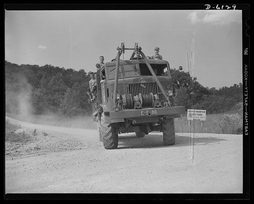 Fort Knox. Bridge construction trucks. Engineer units of the armored forces use special trucks like this for tansporting and placing treadway bridges. Equipped with winches and crane members, these vehicles make quick work of laying bridge sections on pontons. This particular truck is in use at Fort