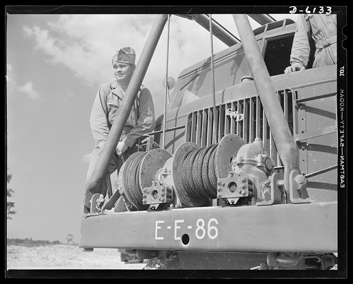 Fort Knox. Bridge construction trucks. Soldiers of a special engineering unit attached to the armored forces prepare to lay a treadway bridge. Equipped with winches and crane members, the bridge truck they use makes short work of transporting the bridge sections and laying them on pontoons. This par