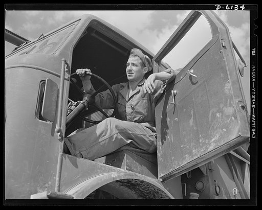Fort Knox. Bridge construction trucks. Driver of a special bridge truck used by engineer units attached to the armored forces. Equipped with winches and crane members, these trucks make short work of transporting treadway bridge sections and laying them on pontoons. This particular truck is in use a