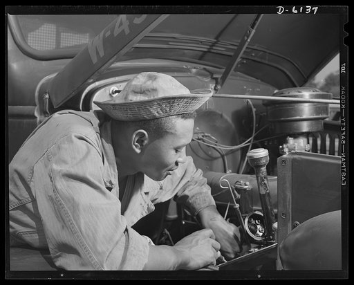 Fort Knox. Negro mechanics. A good ignition job on an army truck. This Negro soldier, who serves as truck driver and mechanic at Fort Knox, Kentucky, plays an important part in keeping army transport fleets in operation