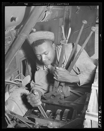 Fort Knox. Negro mechanics. Transmission job on an army truck at Fort Knox, Kentucky. This Negro soldier, who serves as truck driver and mechanic, plays an important part in keeping the army's transport fleets in service