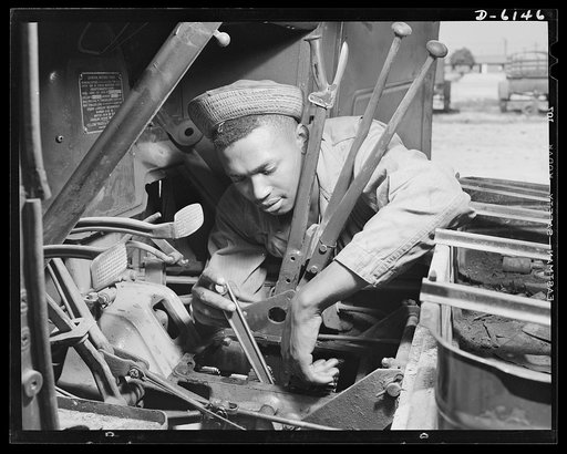Fort Knox. Negro mechanics. Transmission job on an army truck at Fort Knox, Kentucky. This Negro soldier, who serves as truck driver and mechanic, plays an important part in keeping the army's transport fleets in service