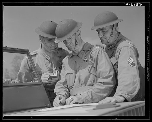Fort Knox. Armored force personnel. A captain, a lieutenant-colonel and a staff sergeant of the armored forces discuss tactical problems during war games at Fort Knox, Kentucky, where soldiers in training are learning the most up-to-date methods of fighting a mechanized war