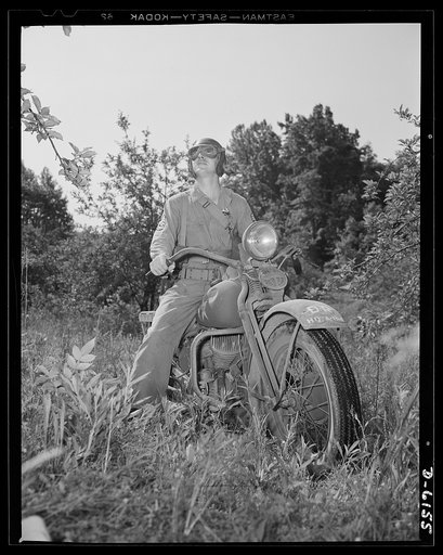 Fort Knox. Armored force personnel. A first sergeant of the armored forces pulls his motorcycle to a standstill to study the effect of a tactical move during war games at Fort Knox, Kentucky, where young soldiers are learning the latest tricks of mechanized warfare