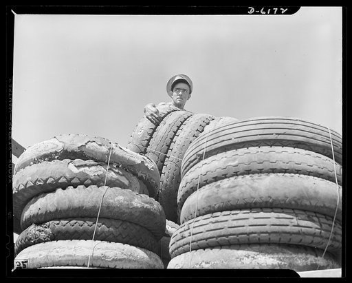 Salvage. Scrap tires. On their way to swell America's most important  stockpile. Employees of a large Southern junkyard load scrap tires for shipment to a reclaiming plant where the rubber will be removed and processed into essential war materials