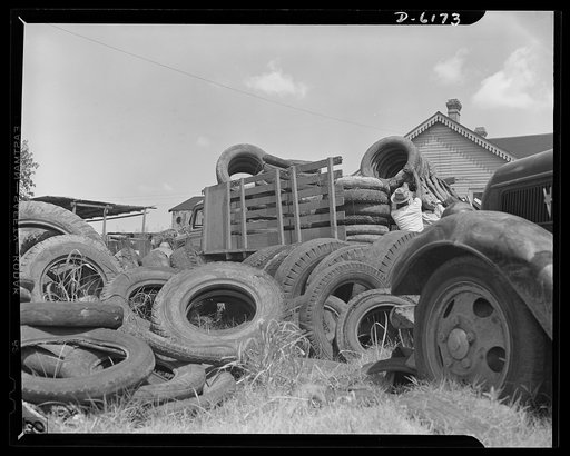 Salvage. Scrap tires. On their way to swell America's most important  stockpile. Employees of a large Southern junkyard load scrap tires for shipment to a reclaiming plant where the rubber will be removed and processed into essential war materials