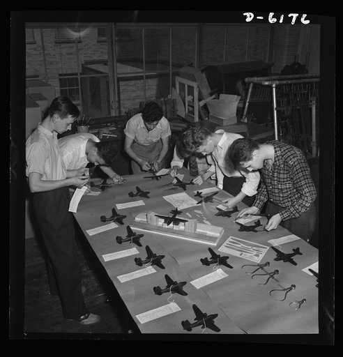 Training high school boys to identify planes. Student's test model planes for accuracy of specification, in a basic aviation course given at Weequahic High School, Newark, New Jersey