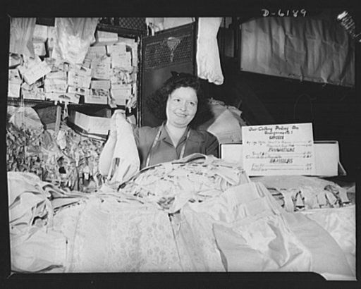 Posting ceiling prices in foreign languages. Ann Samet is one of hundreds of tenants of New York's East Side marketplaces who are cooperating with their government by displaying prominently their price ceiling listings. They represent every conceivable nationality and the war is giving them the oppo