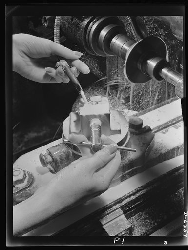 Production. Machine guns of various calibers. Machining a switch pivot for a machine gun in a large Eastern plant. Women's hands are playing a prominent role in this plant producing essential weapons for the armed forces