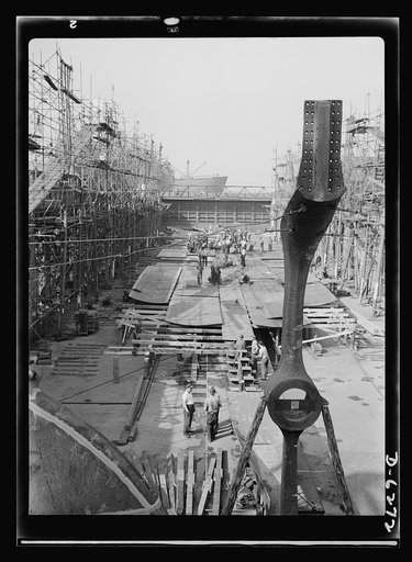 Ship launching in Portland, Maine. The keel is laid for a cargo-carrying ship at a large New England shipyard which sent eight vessels into the water at a mass launching on August 16, 1942--the greatest tonnage ever to leave a Maine dock in one day