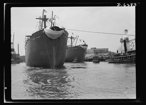 Ship launching in Portland, Maine. Bearing the huge Allied "V" for victory, Ocean Gallant, a cargo carrier built for Britain under lend-lease, is towed out to sea after a mass launching at a New England shipyard. The ship was christened by Mrs. Peter V.O. Evans, wife of the director of the British M