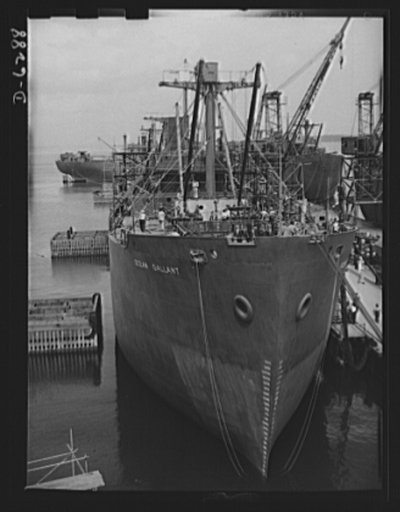 Ship launching in Portland, Maine. Ocean Gallant, one of five British cargo-carrying ships launched in New England on August 16, 1942, when eight vessels went into service. The shipyard where it was built had only six employees two years ago; today 26,000 workers are employed there