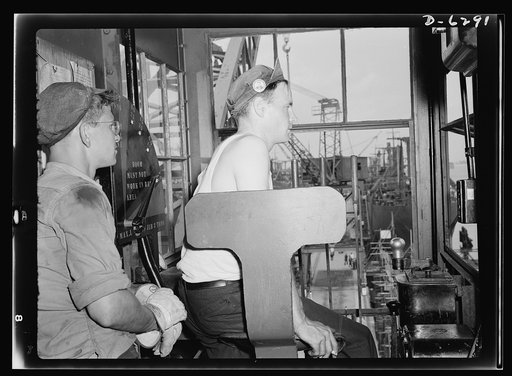 Ship launching in Portland, Maine. The men behind the launchings. High in the cab of a whirley crane, these workers operate the derrick which raises the iron gates and releases water into the dock where ships were built. Eight vessels were put into service in a mass launching on August 16, 1942, in 