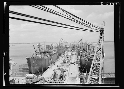 Ship launching in Portland, Maine. Some of the five British cargo-carrying ships built under lend-lease at a large New England yard and launched along with two destroyers and one liberty ship at a record breaking mass launching on August 16, 1942