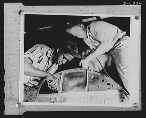 Americans all. In the armed forces and on the production line, Americans of every race and creed fight shoulder to shoulder to defeat the forces which threaten to destroy our liberties. Here, Lewis Ward (left) and Walter Shippe work on the bulkhead of the fuselage of a P-47 pursuit ship. Republic Ai