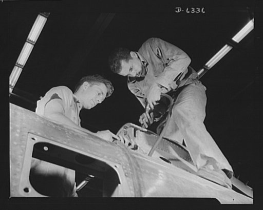 Americans all. Working together for victory, Walter Shippe and Artie Jackson (Negro worker) assemble a pilot's headrest on a P-47 pursuit ship in an Eastern aircraft factory. Republic Aircraft Corporation