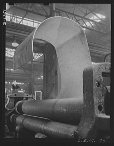 Production. Locomotives. Heavy steel plates are bent on the Southwark bending roll of a large Eastern plant now producing tanks, locomotives, and ship propellers for our armed forces. Baldwin Locomotive Works