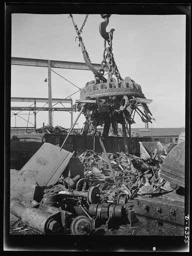 Automobile salvage. When the scrap is sorted, powerful electric cranes load it into freight cars--each type and grade in a separate car. The crane transfers the scrap from the sorted pile to the car in a matter of moments. To conserve railroad car space and time, each car is completely filled before