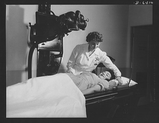 Health and welfare activities. North American Aviation. An X-ray examination to locate the source of internal pain is about to be given to this young worker at North American Aviation in Inglewood, California. Expert medical attention is given all workers at NAA in the modern company hospital rooms