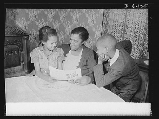 Manpower, junior size. "Helping Uncle Sam is the best possible work for you," Mrs. Bertha Traynham, an evangelist, tells her grandchildren, junior commandos in Roanoke, Virginia. The children have brought her leaflets explaining the necessity of the scrap collection drive