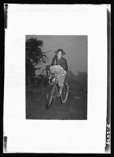 Manpower, junior size. "Neither rain nor snow...nor gloom of night...stays this courier from the completion of his appointed rounds." A junior commando of Roanoke, Virginia, this boy scout makes the weekly rounds of all available scrap in the neighborhood, despite unfavorable weather
