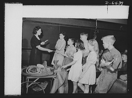 Manpower, junior size. Notes from parents giving permission to their sons and daughters to join the Roanoke, Virginia junior army are received by teacher Doris Jordan. Now these newly appointed junior commandos are ready to collect scrap for victory