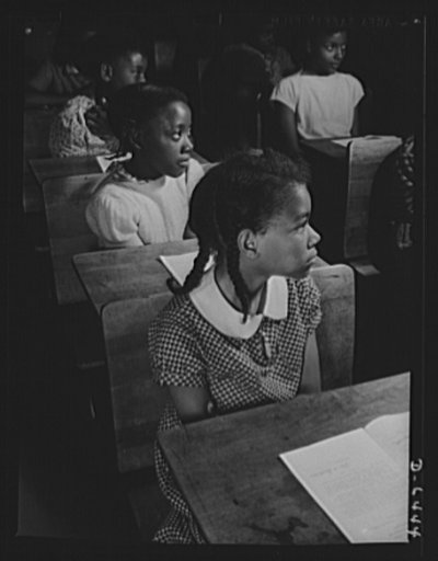 Manpower, junior size. Mild-looking little girls of Roanoke, Virginia, but they are "scrappers for victory." The little sisters of our fighting men back up their big brothers at the front by joining America's junior army. These fifth graders receive final instructions from their teacher on the scrap